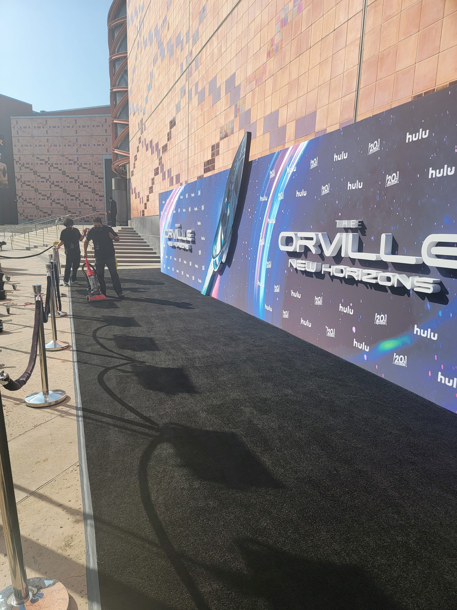 At ER Janitorial Services, our event cleaners are dedicated to ensuring that your event looks good and is presentable for your guests. In this image, our team is shown vacuuming the arrival carpets for a Hulu series premier of The Orville. 